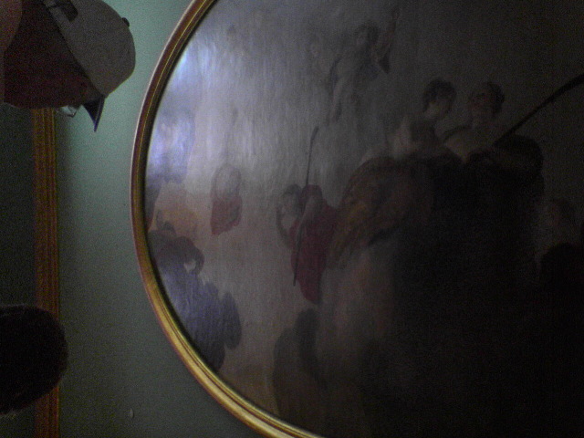 Painting on ceiling over bed