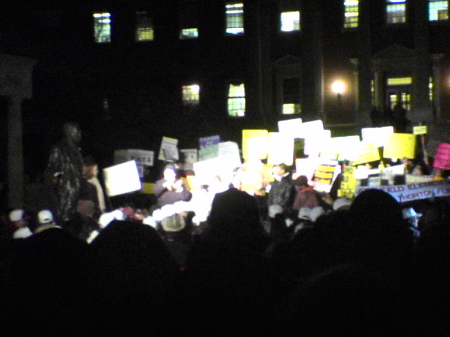 Speakers and signs in front of Thurgood Marshall statue 